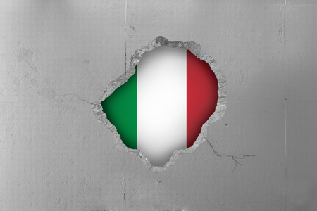 Italian flag behind a concrete wall.の写真素材