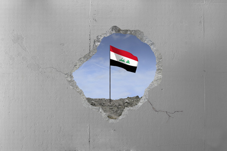 Iraq flag behind a concrete wall.の写真素材
