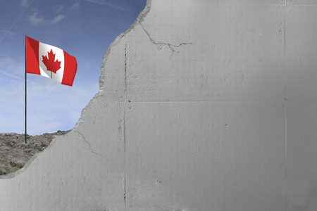 Canadian flag behind a concrete wall.の写真素材