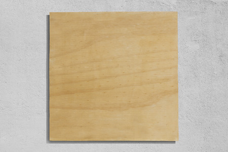 Square plywood sign with rough wall background.の写真素材