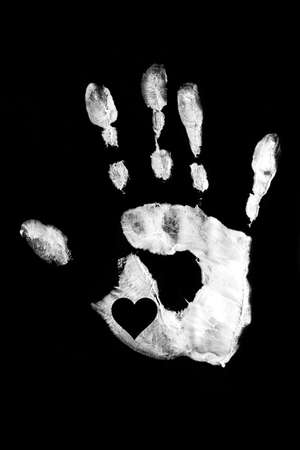 White handprint with heart on a black background.Together. Palm print as a symbol of racial equality. Stop racism.の写真素材