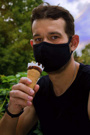 Anti covid mask as a barrier when licking ice cream.