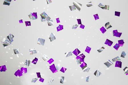 The party is over. Sweep the confetti off the floor. Purple and silver shiny confetti on a white floor.の写真素材