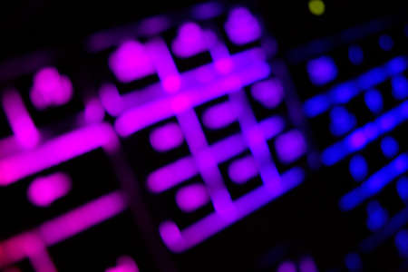Abstract background created by blur glowing keyboard.Rainbow concept for modern technology, gaming...
