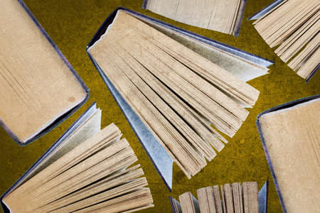 Top view of several books. Seven books stand on a brown background. Celebrate Book Day by reading or buying a new book for your collection.の写真素材