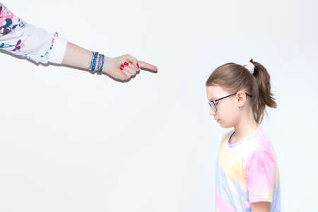 A woman probably mom scolds a little girl. The little girl is sad. Something went wrong and Mom is...