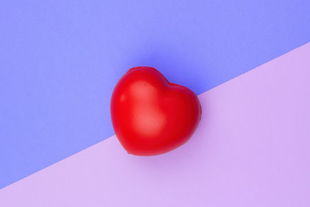 Red hearts on background in two shades of lilac.Protect your heart. Concept for red heart symbol.の写真素材