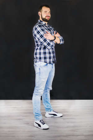 Young man standing on office and smiling. Working photo from the office. Careless elegance and casual style.の写真素材