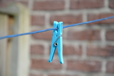 Clothespin hanging on lineの写真素材