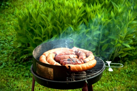Sausages barbecuing on the hot grillの写真素材