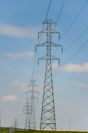 High voltage pylon close to motorwayの写真素材