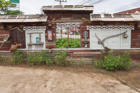 Wall pictures decorated with ancient plow equipment And pottery water jug.の写真素材