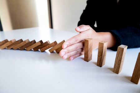 Woman hand stop blocks wood for protect other, Concept Risk of management and strategy plan.の写真素材