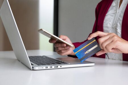 Business woman consumer holding credit card and smartphone for online shopping and payment make a purchase on the Internet.の写真素材