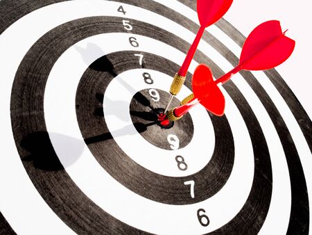 Target with three red dart focus on bull's eye, Setting challenging business goals And ready to achieve the goal with teamwork concept.の写真素材