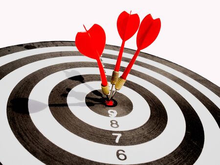 Target with three red dart focus on bull's eye, Setting challenging business goals And ready to achieve the goal with teamwork concept.の写真素材