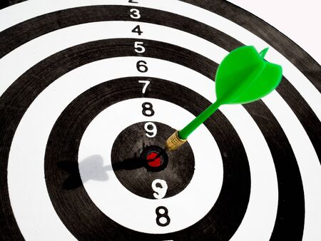 Target with green dart focus on bull's eye, Setting challenging business goals And ready to achieve the goal concept.の写真素材