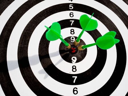 Target with three green dart focus on bull's eye, Setting challenging business goals And ready to achieve the goal with teamwork concept.の写真素材