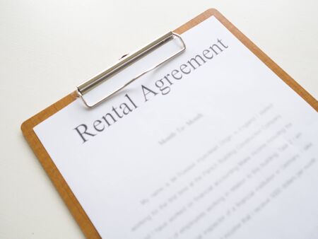 A car rental service lease contract on wooden clipboard.の写真素材
