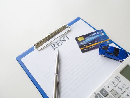 A car rent service lease contract with key credit card and calculator.の写真素材
