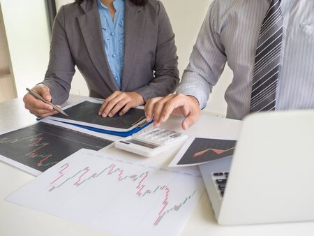 Trader team discussion and analyze stock graph report, set targets for online trading management success.の写真素材