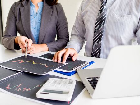 Trader team discussion and analyze stock graph report, set targets for online trading management success.の写真素材