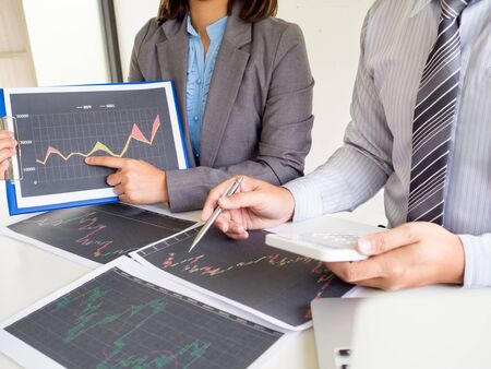 Trader team discussion and analyze stock graph report, set targets for online trading management success.の写真素材