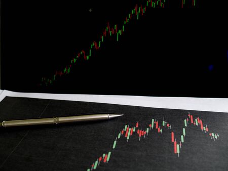 pen was put on stock trading graph for 
Stock market analysis, set targets for online trading management success.の写真素材