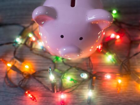 Pink piggy bank with Party lights, Enjoy savings for the holidays concept.の写真素材