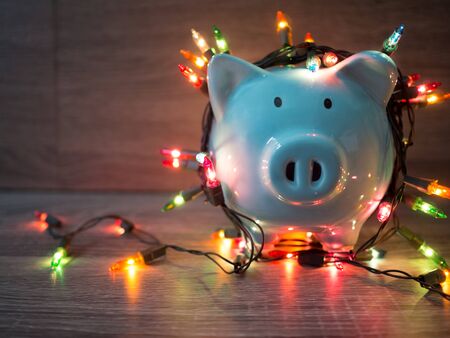 Blue piggy bank with Party lights, Enjoy savings for the holidays concept.の写真素材