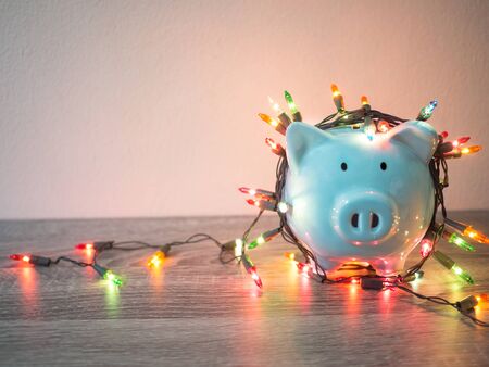 Blue piggy bank with Party lights, Enjoy savings for the holidays concept.の写真素材