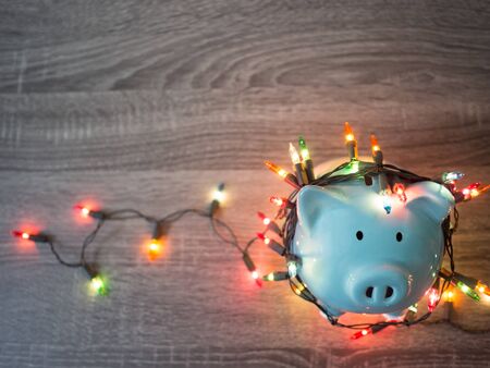 Blue piggy bank with Party lights, Enjoy savings for the holidays concept.の写真素材