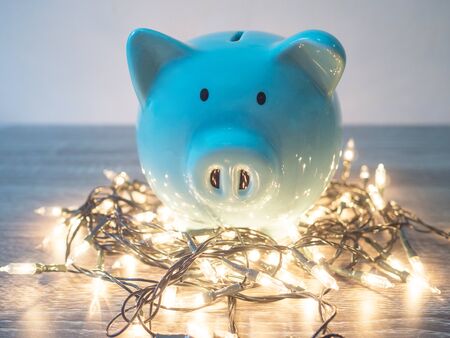 Blue piggy bank with Party lights, Enjoy savings for the holidays concept.の写真素材