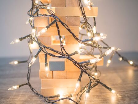 Wooden block tower with Party lights, Funly Planning Alternative Risk management and Strategy in Business concept.の写真素材