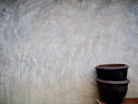 Plant pots and cement wall background for your creative imagination.の写真素材