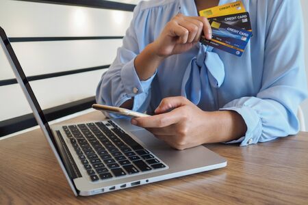 Business woman consumer spending via credit card and internet banking for shopping online.