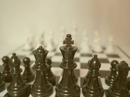Black and white chess-Army are standing on a board, challenges planning business strategy to success...