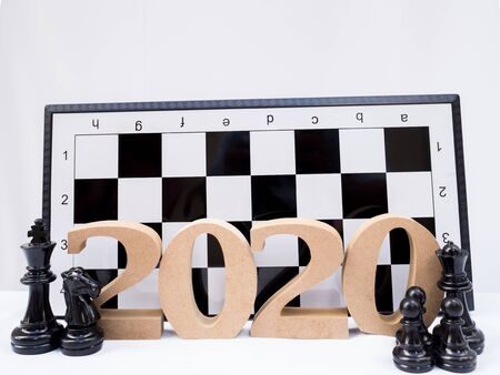 2020 wooden character with chess on white background, Have a nice holiday on this New Year.