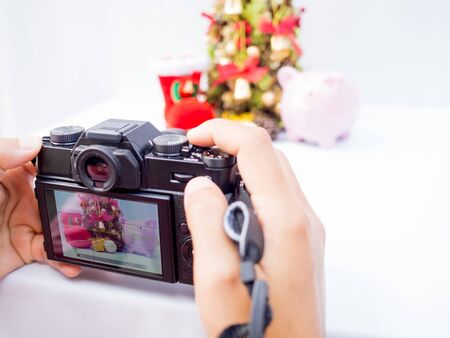 The photographer is intending to use digital camera take pictures of the Christmas decoration, Have...