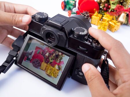 The photographer is intending to use digital camera take pictures of the Christmas decoration, Have...