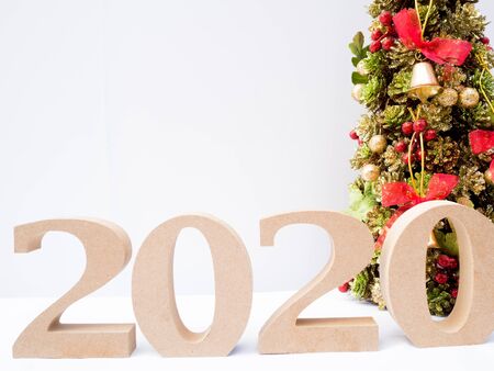 2020 wooden character and Christmas tree with decoration on white background, Have a nice holiday on...