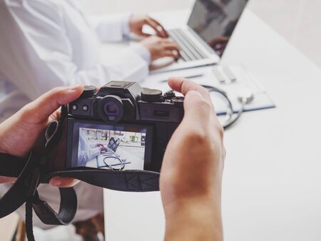 photographer used digital camera to take photo the doctor.