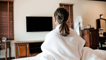 Photo of young woman sitting in the bed after wake up.の写真素材