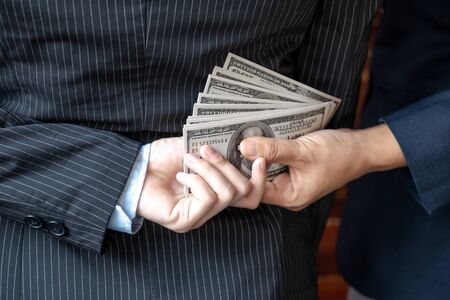 Back side of Business woman who give bribe to the officer, Corruption concept.