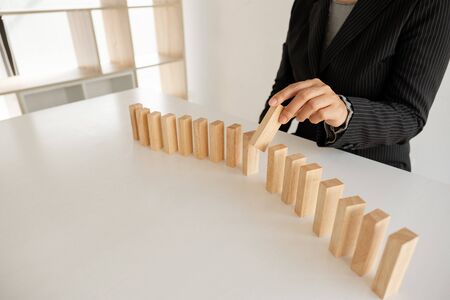 Hand holding blocks wood game, Concept Risk of management and strategy plan, growth business success process and team work.の写真素材