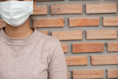 The women wearing the mask to the wrong side, Fight in disaster covid19.の写真素材