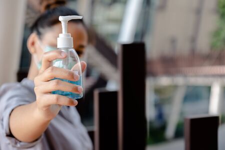 The women hand holding alcohol gel, Make a symbol  fight in disaster covid19.の写真素材