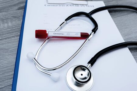 The picture of blood tube of coronavirus test and stethoscope in white background.の写真素材