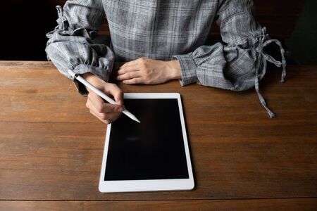 Picture of business woman working at home with her tablat.の写真素材
