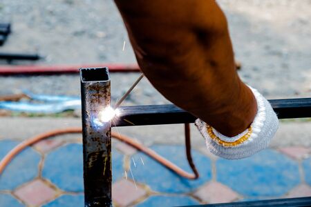 The mechanic is using a welding machine to weld steel.